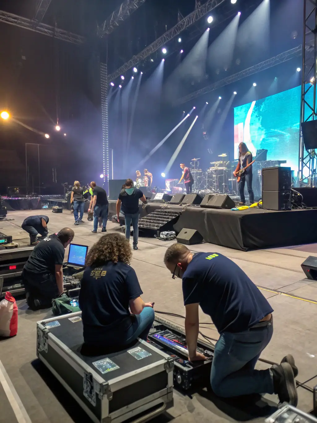 A picture of volunteers setting up equipment for a local theater production, highlighting the collaborative spirit and community involvement fostered by Very Good Vibes.